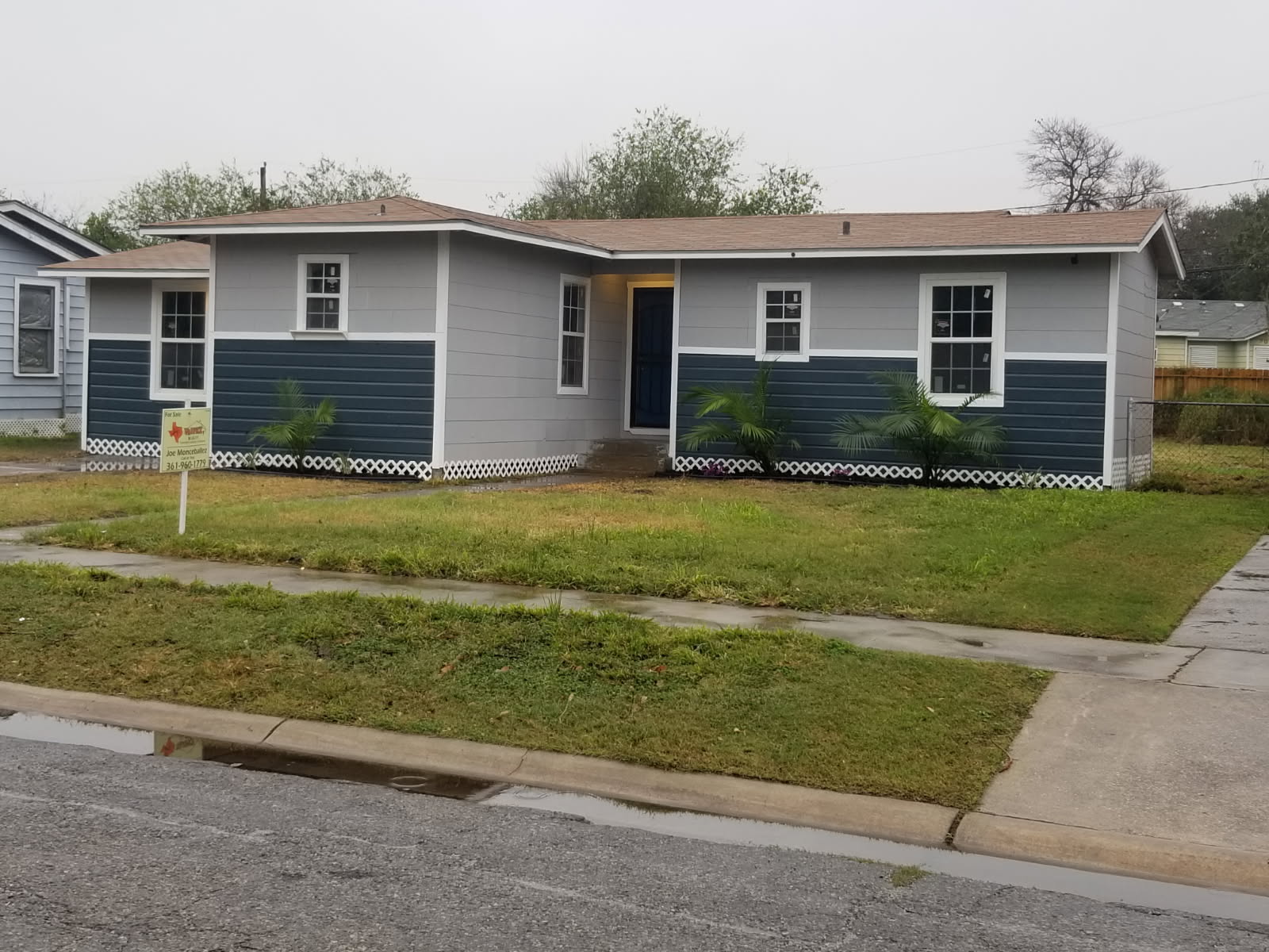 Fully renovated Corpus Christi home with fresh two-tone siding and Joe's for-sale sign out front