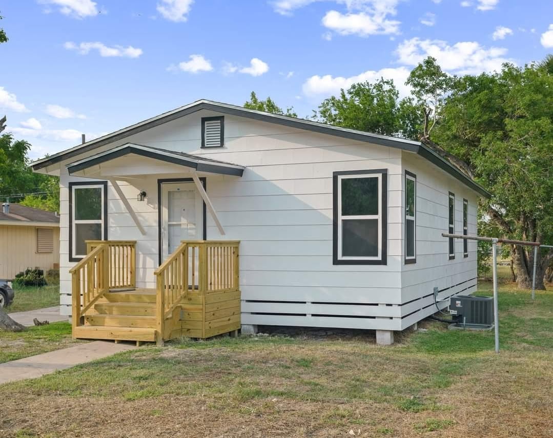 Renovated cottage with fresh white siding and new front porch