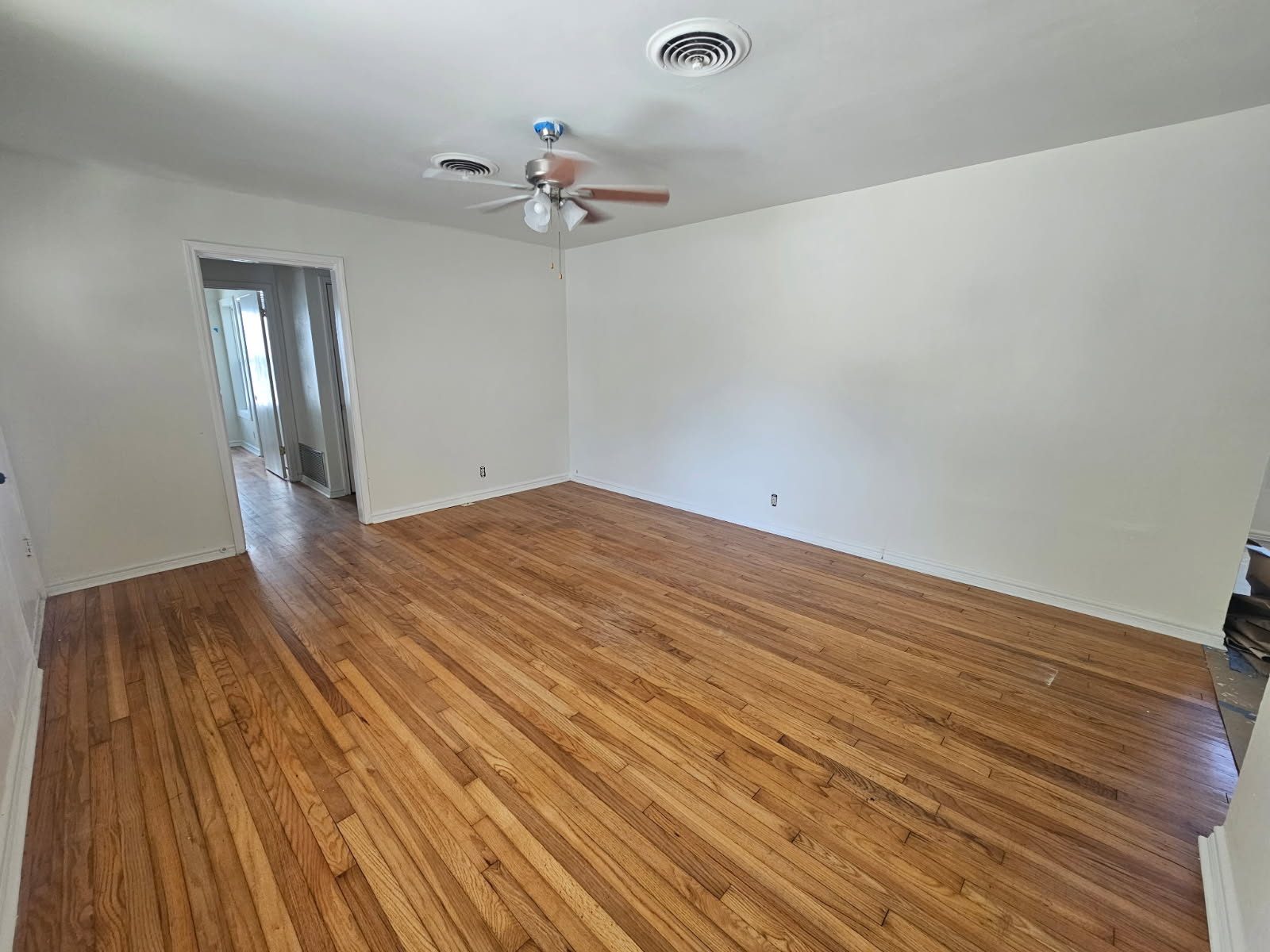 Refinished original oak hardwood floors in a freshly painted Corpus Christi home